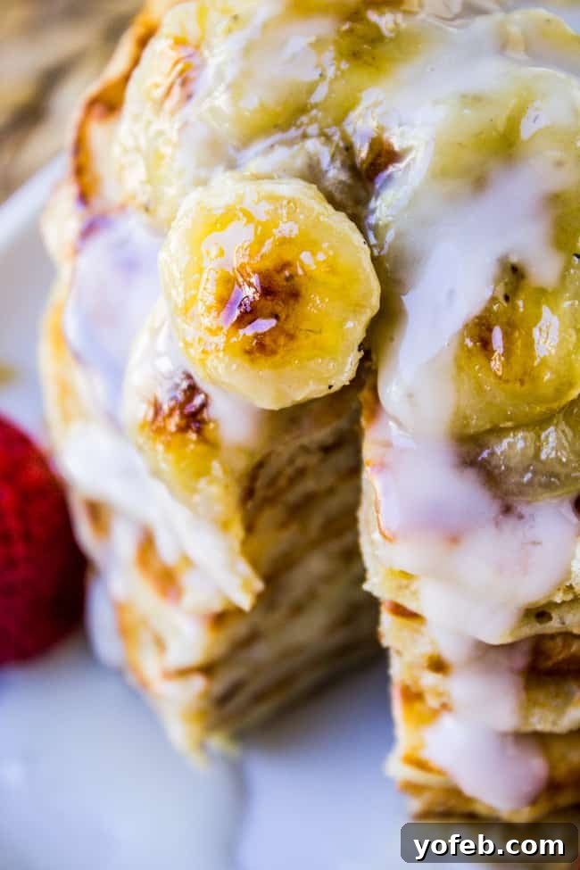 Golden Macadamia Banana Pancakes 3 Stack of Banana Macadamia Pancakes garnished with fresh pineapple, ready to be served