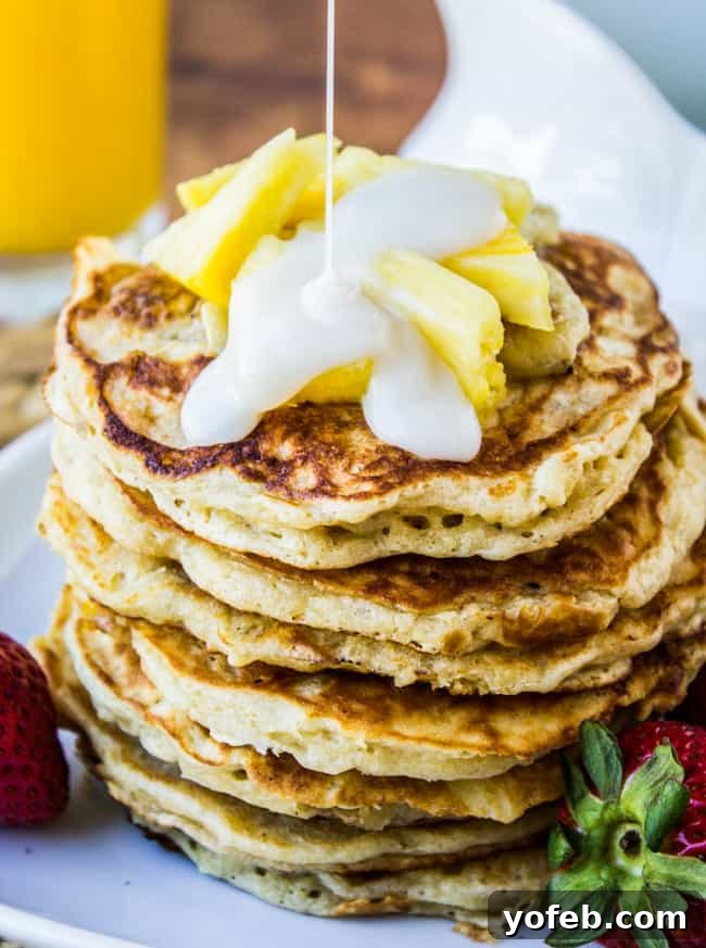 Golden Macadamia Banana Pancakes 5 Overhead view of a stack of Banana Macadamia Pancakes, perfectly golden brown