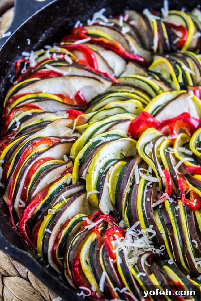 Sun-Kissed Vegetable Bake 6 baked ratatouille in cast iron pan with sprinkled parmesan.