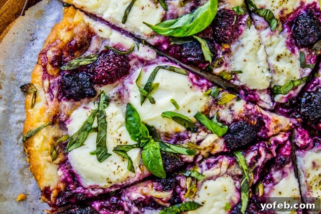 Sweet and Savory Blackberry Ricotta and Basil Pizza 3 Blackberry Ricotta Pizza slice, showing the melted cheese and fruit toppings.