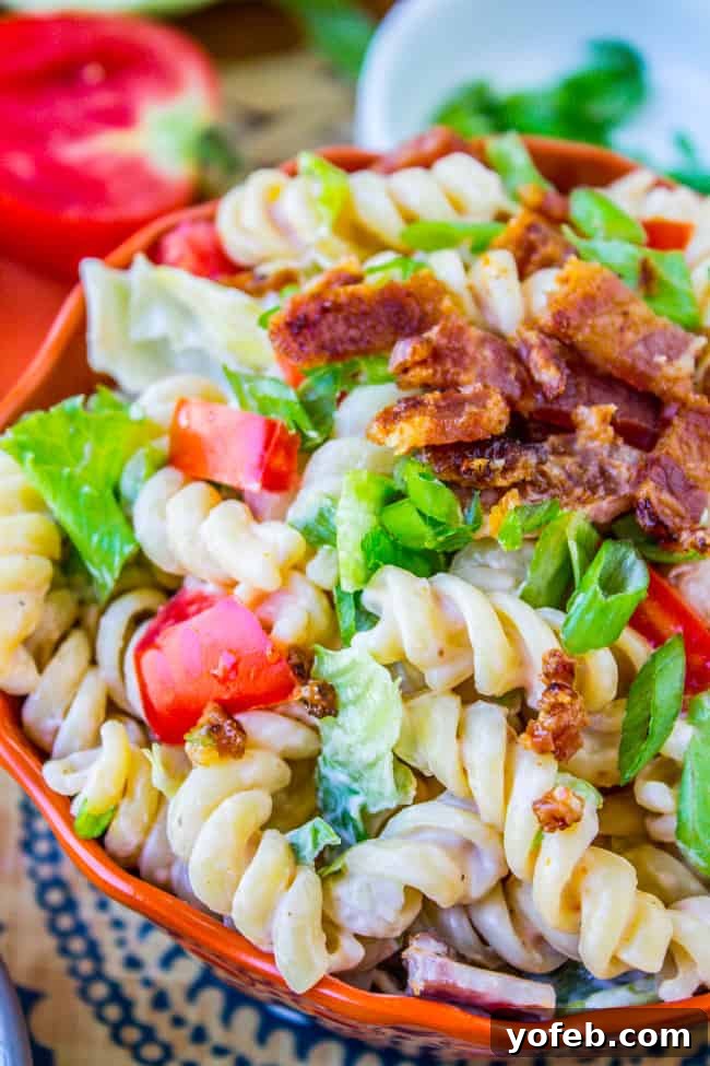 Creamy BLT Pasta Salad 3 BLT pasta salad served in a white bowl, viewed from a slightly elevated angle.