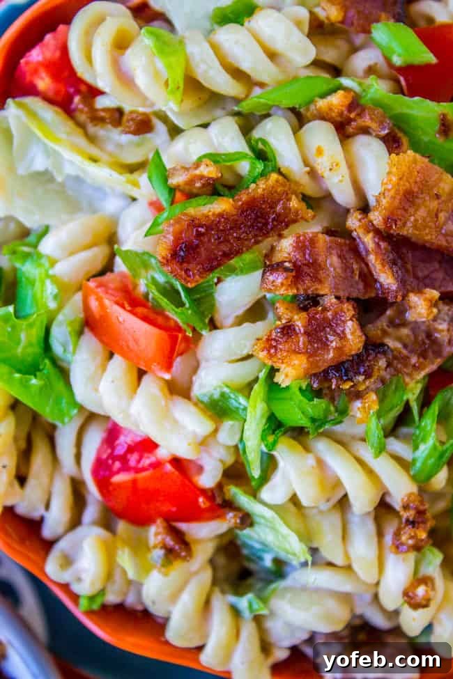 Creamy BLT Pasta Salad 4 A large bowl of BLT pasta salad, with visible pasta, bacon, and lettuce.