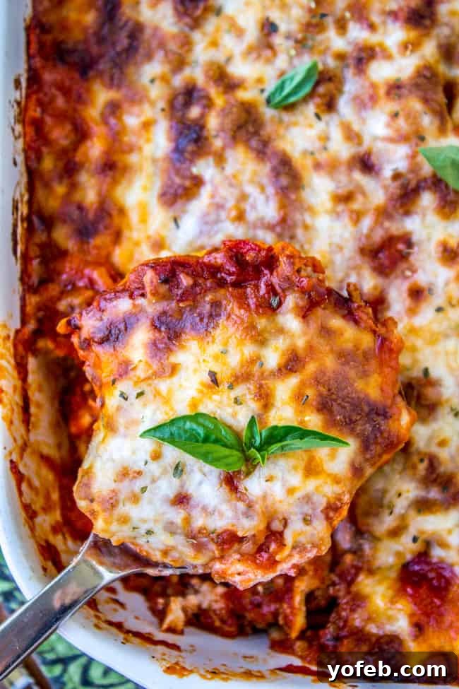 Lazy Lasagna with Ravioli 7 A freshly baked ravioli lasagna adorned with vibrant fresh basil leaves.