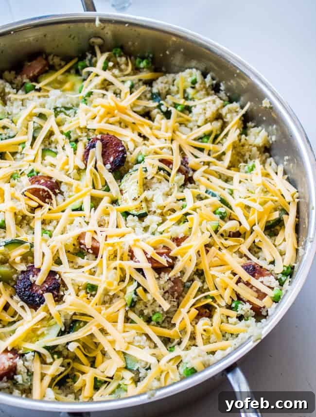 Smoky Kielbasa and Zucchini Cauliflower Rice Skillet 6 Cooked cauliflower rice, zucchini, and kielbasa with melted cheese ready to serve