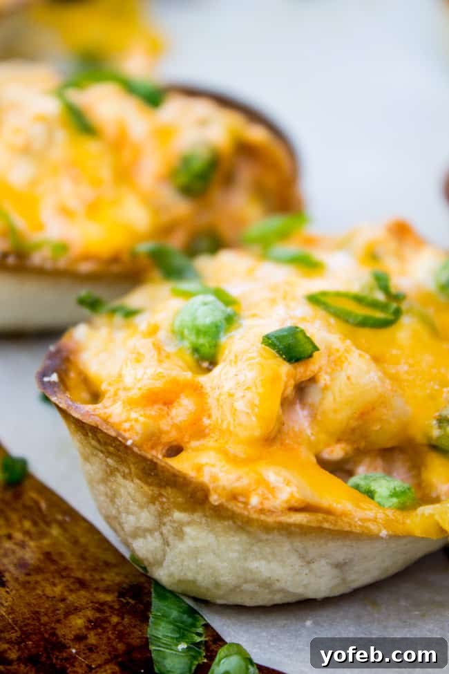 Loaded Buffalo Chicken Boats 3 Close-up of baked Cheesy Buffalo Chicken Boats filled with spicy chicken and melted cheese