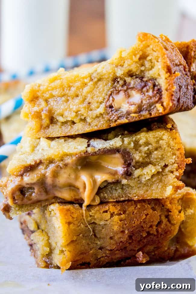 Luscious Caramel Almond Butter Bars 5 Stacked Caramely Almond Butter Bars with a bite taken out, showing gooey center