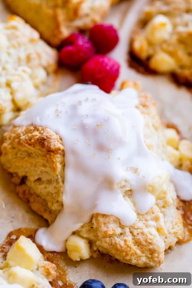A golden-brown glazed scone generously sprinkled with coarse sugar, glistening under the light and ready to be savored.