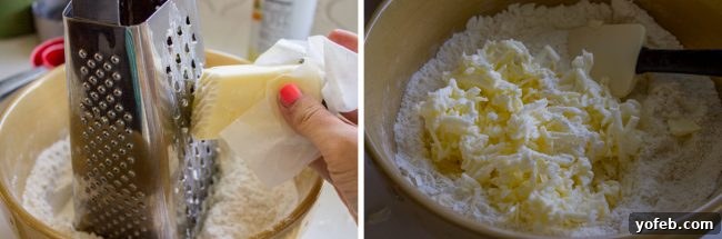 A close-up shot of frozen butter being grated directly into a bowl of dry ingredients, illustrating a key technique for flaky scones.