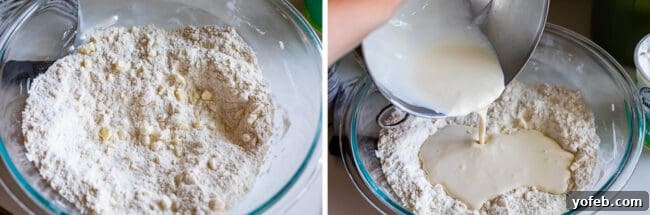 Hands gently mixing together the wet and dry ingredients in a large bowl, starting to form the shaggy scone dough.