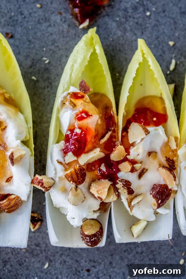 Smoky Almond & Cream Cheese Endive Boats 2 Smokey Almond Cream Cheese Endive Bites - A perfect blend of creamy, sweet, spicy, and crunchy flavors on a fresh endive leaf.