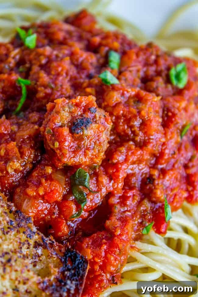 Effortless Slow Cooker Pasta Sauce 10 Spaghetti sauce with fresh basil and Italian sausage served over pasta.