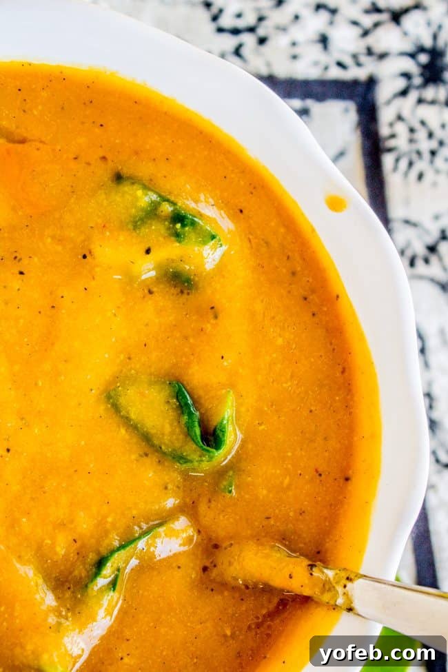 Creamy Vegan Cauliflower Soup 8 a spoon in a bowl of creamy vegan cauliflower soup.