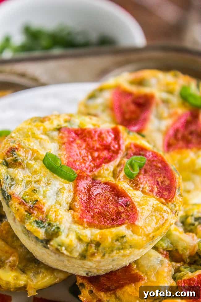 Pizza Egg Muffins: Effortless Weekday Breakfast 3 Stacked egg muffin bakes, one topped with pepperoni, showcasing the vibrant ingredients within.