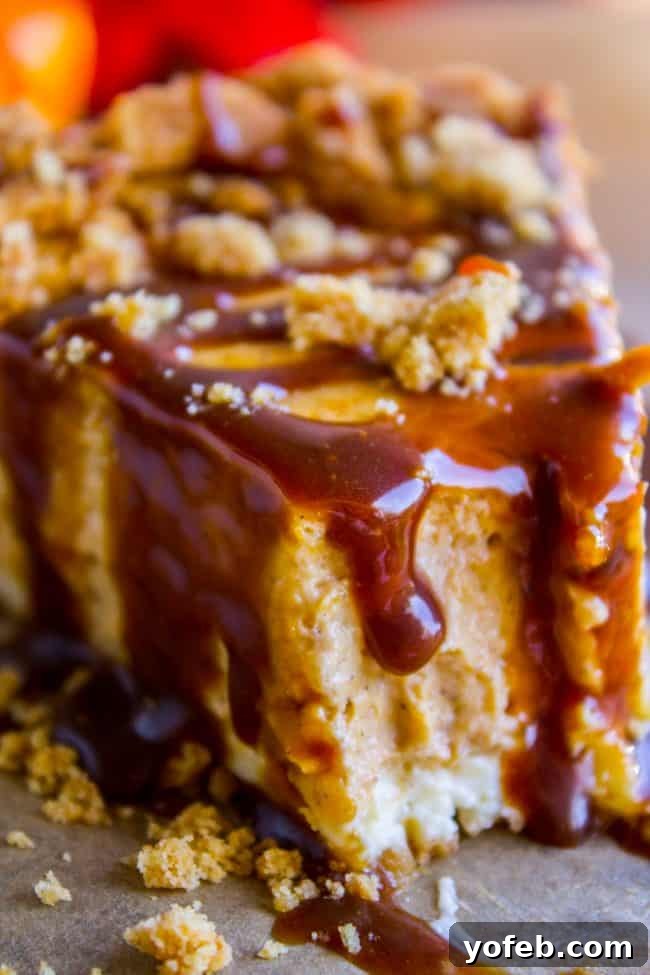 Experience the rich, creamy goodness of a Double Layer Pumpkin Cheesecake – a dessert so good, it's a guaranteed winner every time. A slice of double layer pumpkin cheesecake with a bite taken out, showing the creamy texture and two distinct layers.