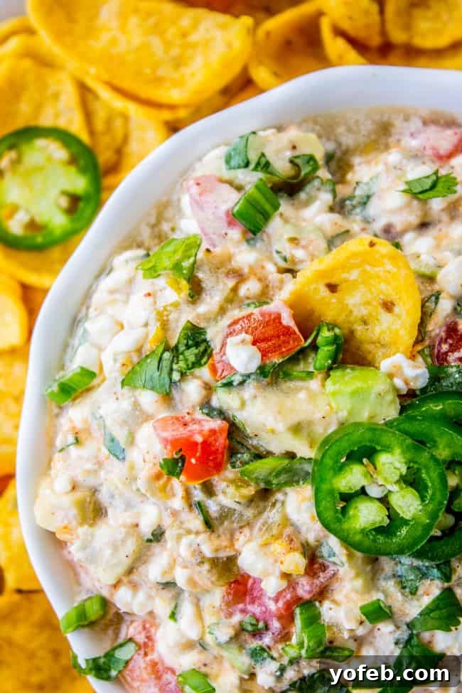 Snow-Capped Chili Cheese Dip 2 Creamy and flavorful Snowy Chili Cheese Dip with Fritos on the side, ready for dipping.