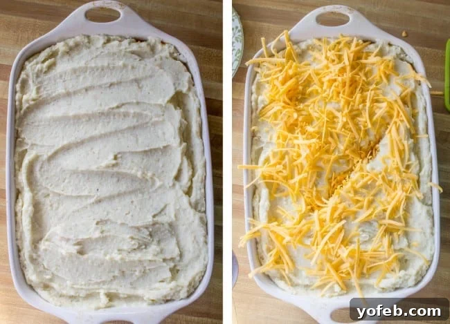 Ultimate Cheesy Shepherds Pie 10 creamy mashed potatoes spread evenly over the beef filling, with shredded cheese sprinkled on top.