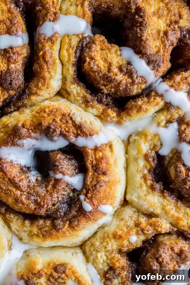 Quick No Yeast Cinnamon Rolls 2 Flaky cinnamon rolls with a generous drizzle of creamy icing.