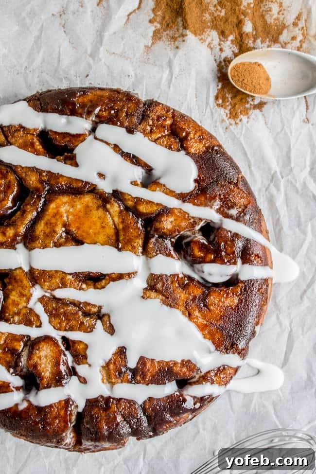 Quick No Yeast Cinnamon Rolls 3 A round pan of freshly baked cinnamon rolls, inverted onto parchment paper, ready for icing.
