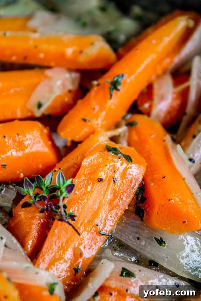 Thyme-Infused Sautéed Carrots and Shallots 4 A serving bowl filled with perfectly sautéed carrots and shallots, ready to be enjoyed.