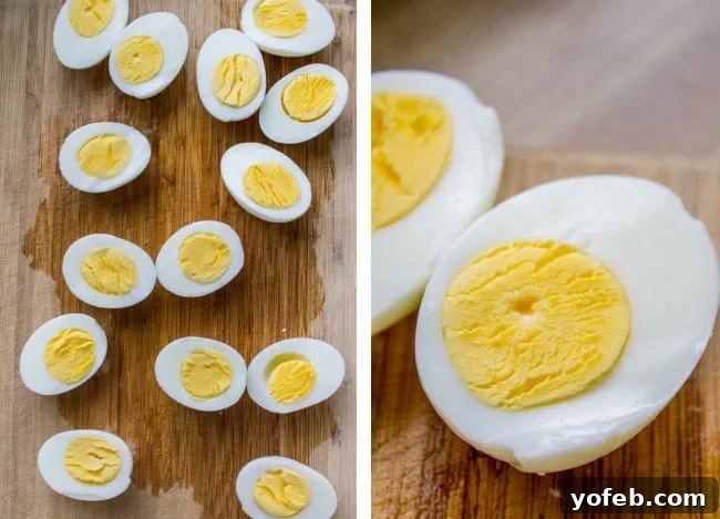 Timeless Deviled Eggs 7 Halved hard-boiled eggs with perfectly cooked, slightly moist yolks arranged on a wooden cutting board, ready for the deviled egg filling.
