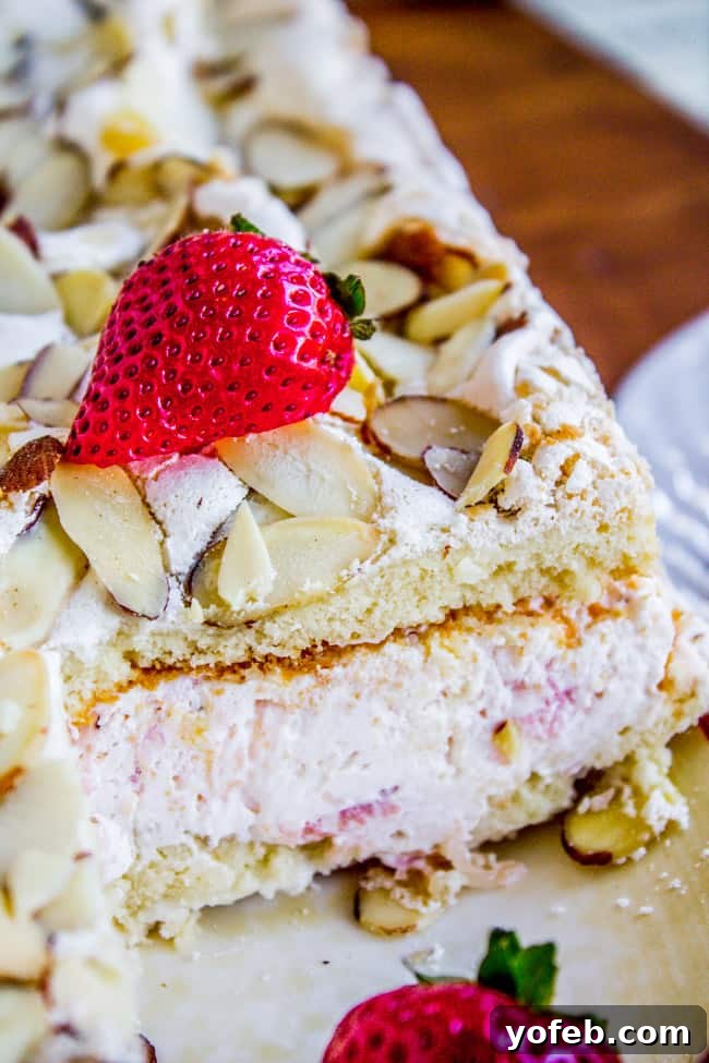 Strawberry Pineapple Meringue Dream Cake 9 Close-up of a slice of Strawberry Pineapple Meringue Cake showing layers