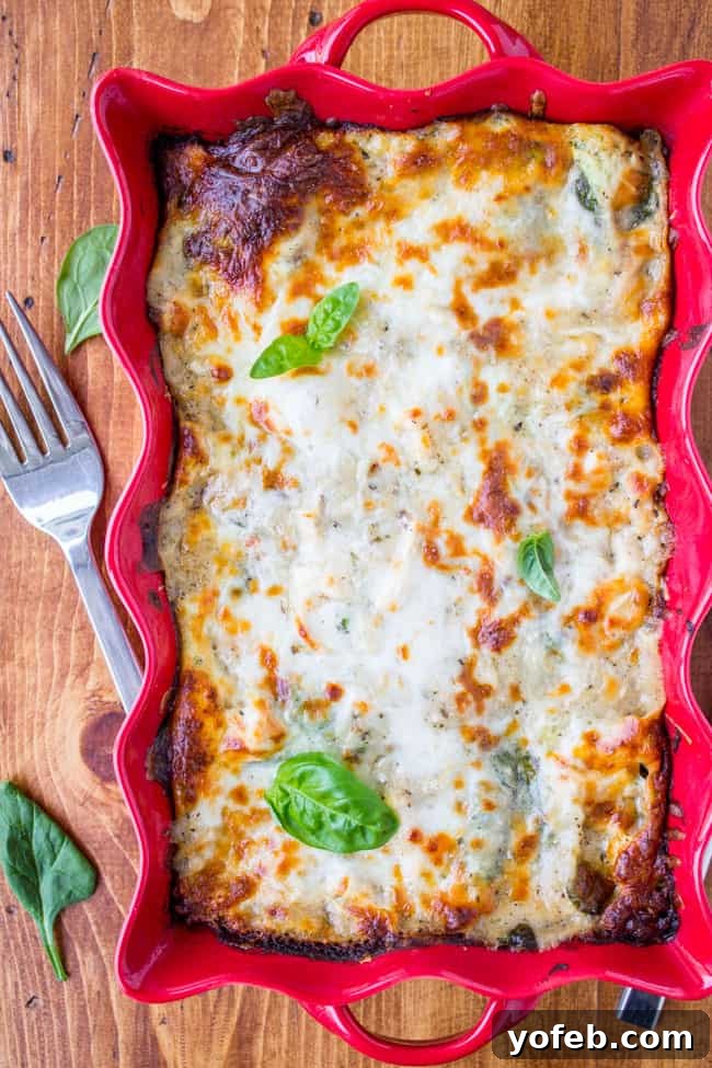 Creamy Chicken Pesto Lasagna 2 Creamy White Lasagna with Chicken and Pesto, garnished with fresh basil