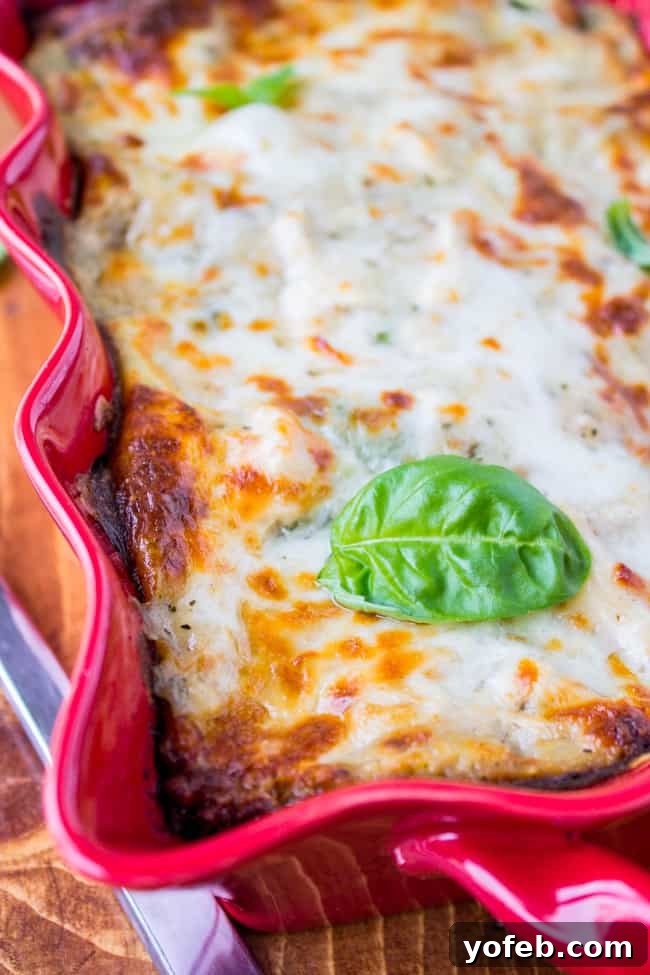 Creamy Chicken Pesto Lasagna 12 A slice of White Lasagna with clear layers of chicken, pesto, spinach, and cheese