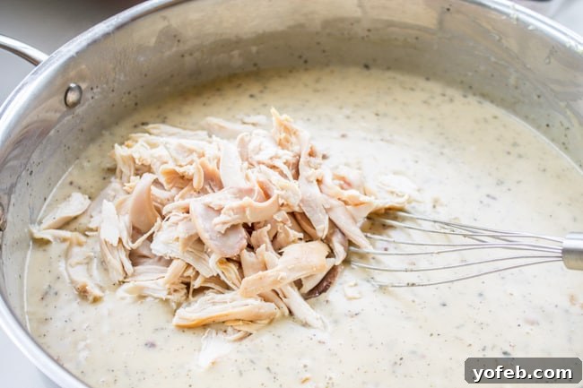 Creamy Chicken Pesto Lasagna 7 Overhead view of White Lasagna baking in a casserole dish
