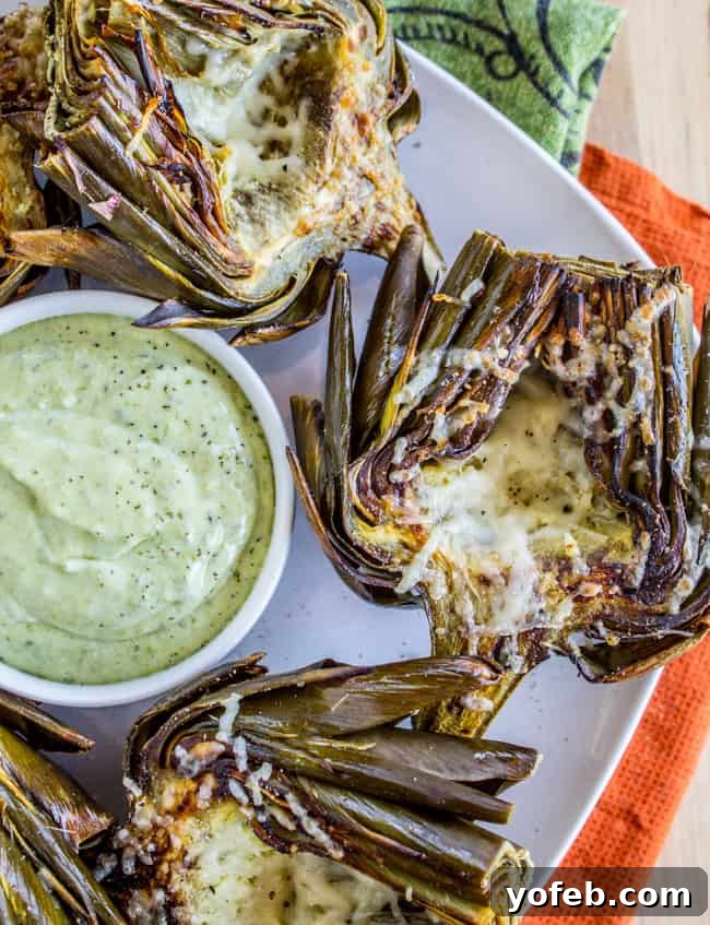 Garlic Roasted Artichokes with Pesto Dipping Sauce from The Food Charlatan