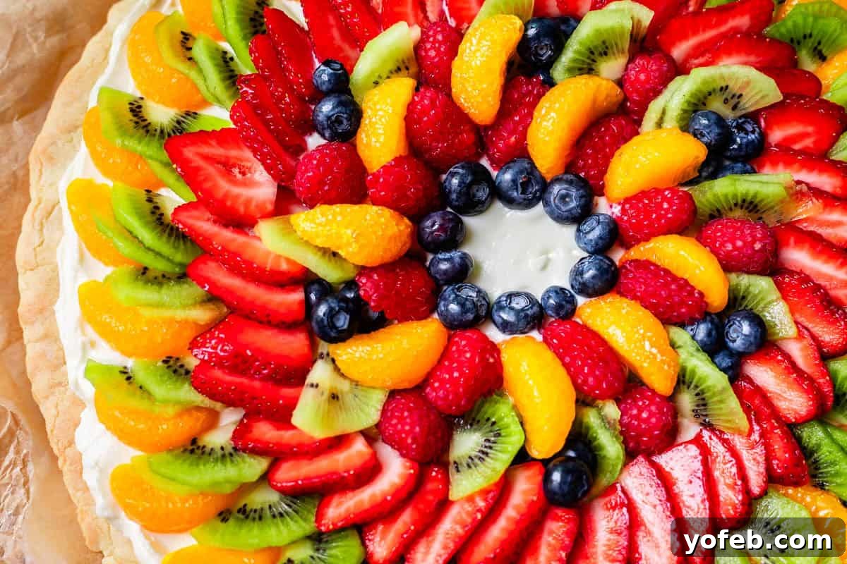 Pillowy Sugar Cookie Fruit Pizza Delight 19 Overhead shot of a fruit pizza with a blank circular section in the middle, ready for more fruit arrangement or a centerpiece.