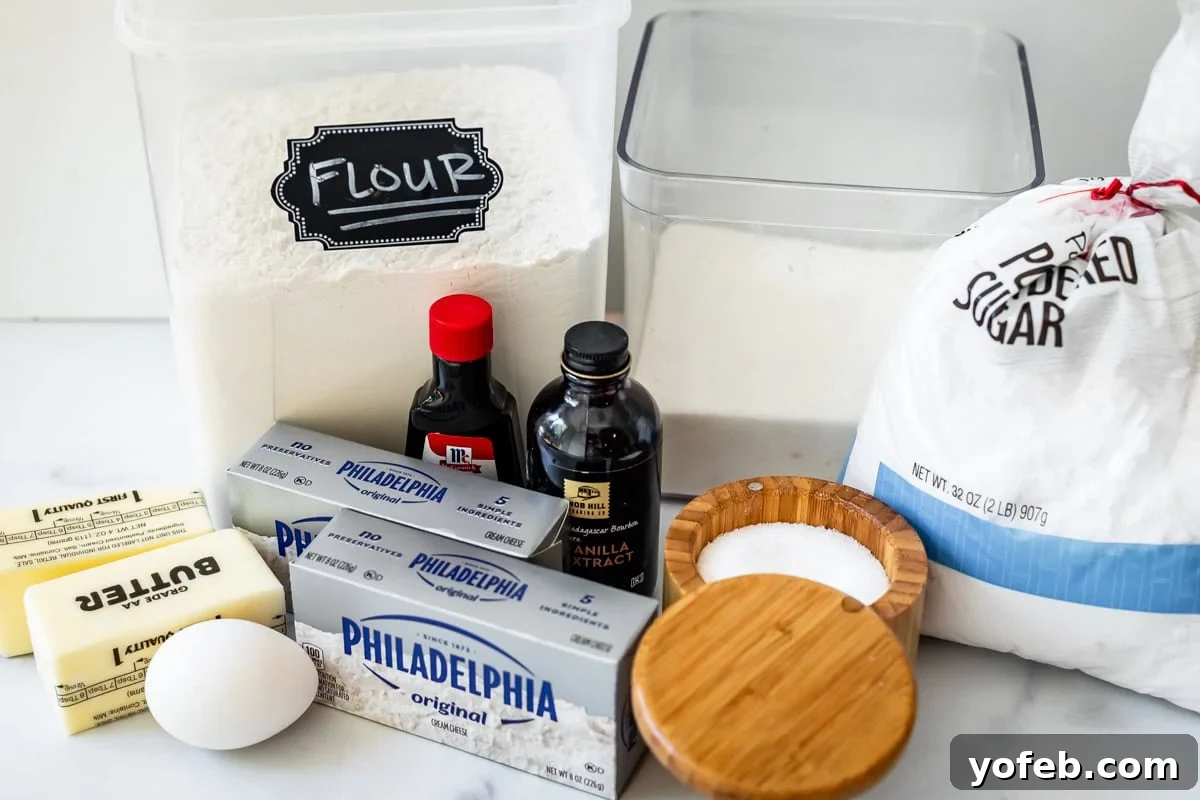 Pillowy Sugar Cookie Fruit Pizza Delight 8 Ingredients for the soft sugar cookie dough, including butter, cream cheese, sugar, egg, extracts, flour, salt, and cornstarch, laid out on a surface.