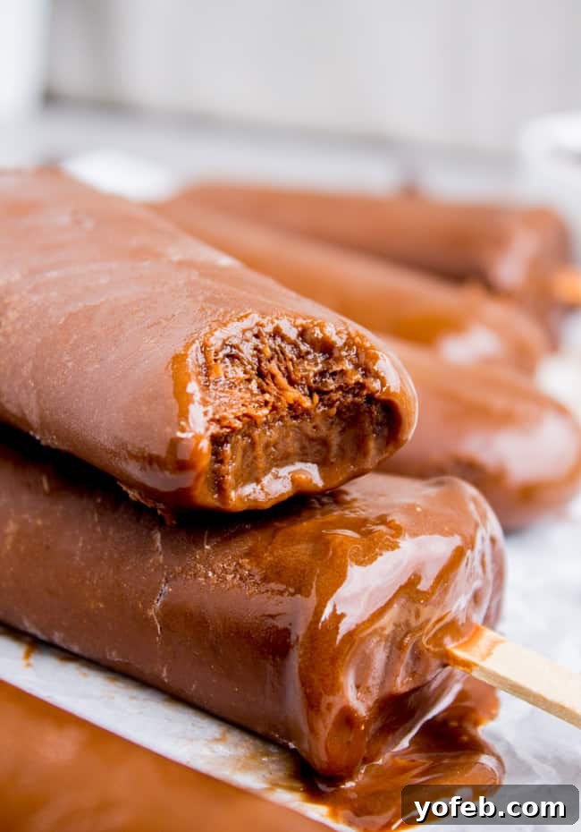 Dreamy Three-Ingredient Fudge Pops 6 Pouring chocolate fudge pop mixture into molds - Step by step guide to homemade popsicles
