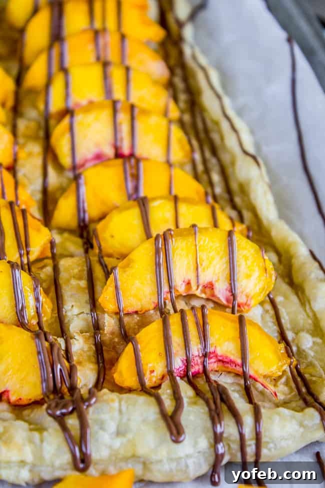 Peachy Nutella Pockets 2 A beautifully arranged Peach and Nutella Puff Pastry, showcasing golden crust and vibrant fruit.