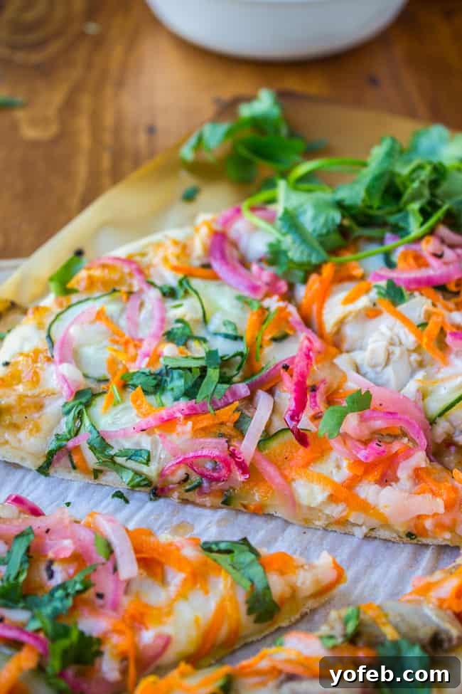 Tangy Thai Zucchini Pizza with Pickled Red Onions 4 Appetizing slices of Thai chicken pizza arranged on a rustic wooden table, ready to eat