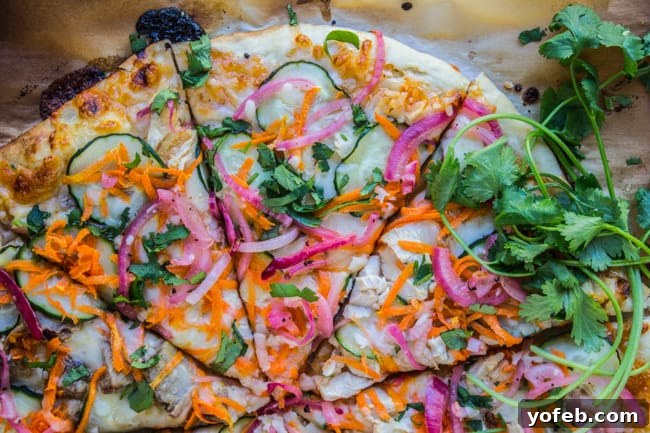 Tangy Thai Zucchini Pizza with Pickled Red Onions 7 Golden brown and cooked Thai pizza on parchment paper, fresh out of the oven