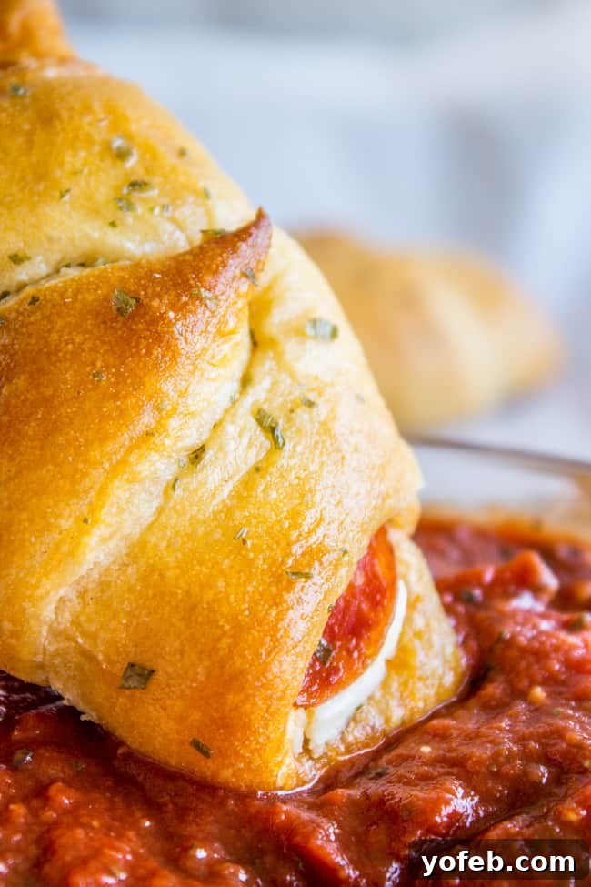 Golden brown Pepperoni Cream Cheese Crescent Rolls on a baking sheet, ready to be enjoyed.