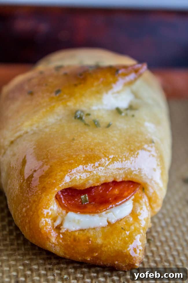Baked Pepperoni Cream Cheese Crescent Rolls arranged on a plate, ready to be served.