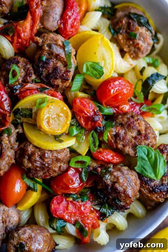 How to Make Italian Sausage Pasta Step A skillet filled with beautifully seared Italian sausage coins and vibrant cherry tomatoes, simmering in a rich broth.