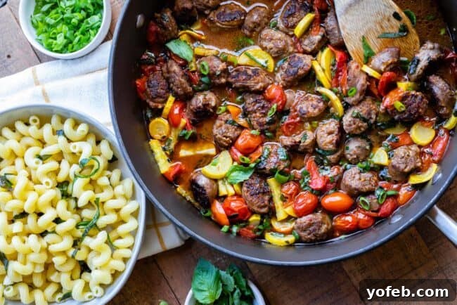 Italian Sausage Pasta Ingredients A bowl of fresh yellow squash, thinly sliced, and a vibrant pile of whole cherry tomatoes, ready for cooking.