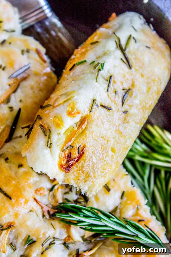 Sizzling Skillet Rosemary Garlic Bread 9 Garlic and Rosemary Skillet Bread in a cast iron pan, ready to be served in wedges.