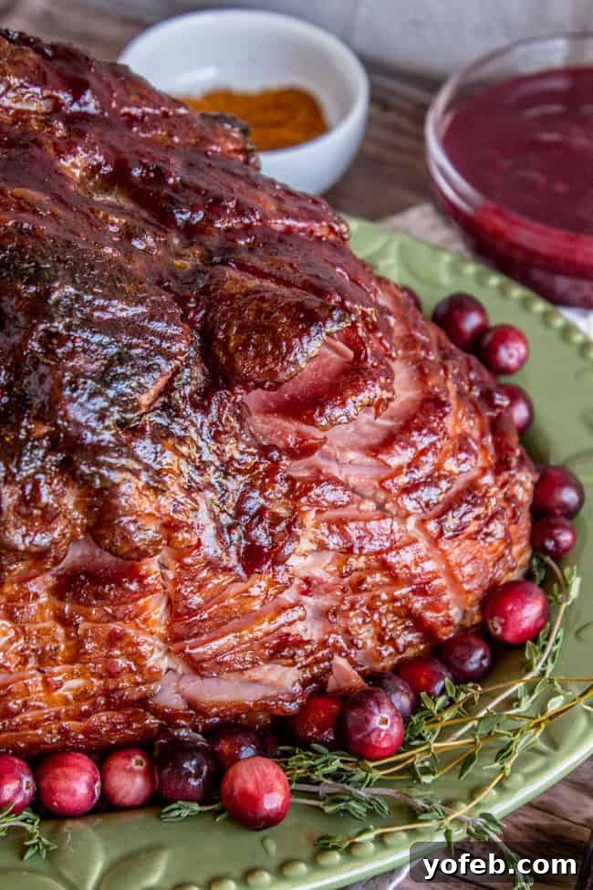 Succulent Roasted Ham with Sweet and Tangy Cranberry Dijon Glaze 3 Spiral ham recipe with glaze, cranberries, and thyme