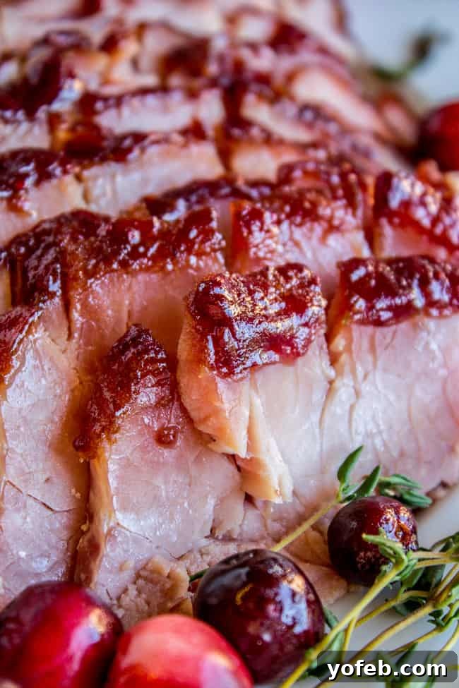 Succulent Roasted Ham with Sweet and Tangy Cranberry Dijon Glaze 4 Close up sliced ham with homemade glaze and cranberries