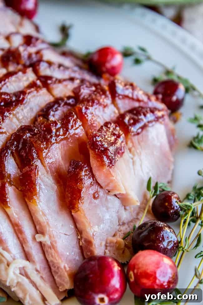 Succulent Roasted Ham with Sweet and Tangy Cranberry Dijon Glaze 10 ham glaze recipe brown sugar, sliced with cranberries and thyme
