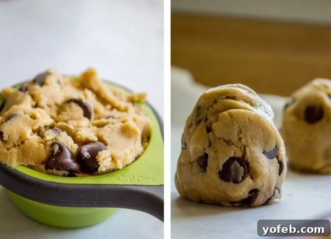 The Ultimate Brown Butter Chocolate Chip Cookies 11 A measuring cup filled with chocolate chip cookie dough, alongside arranged balls of cookie dough on parchment paper, ready for baking.
