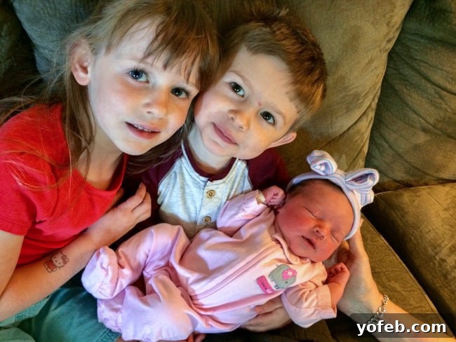 The Ultimate Brown Butter Chocolate Chip Cookies 5 Two young children, a boy and a girl, gently holding their newborn baby sister, smiling with affection.