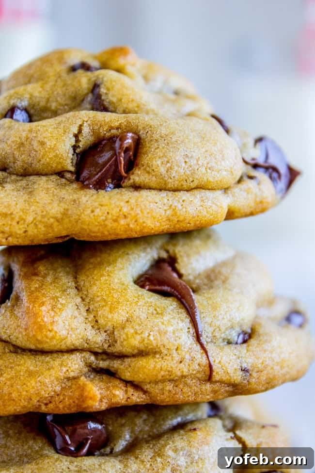 The Ultimate Brown Butter Chocolate Chip Cookies 7 A stack of golden-brown chocolate chip cookies with perfectly melted chocolate chips, enticingly warm and fresh.