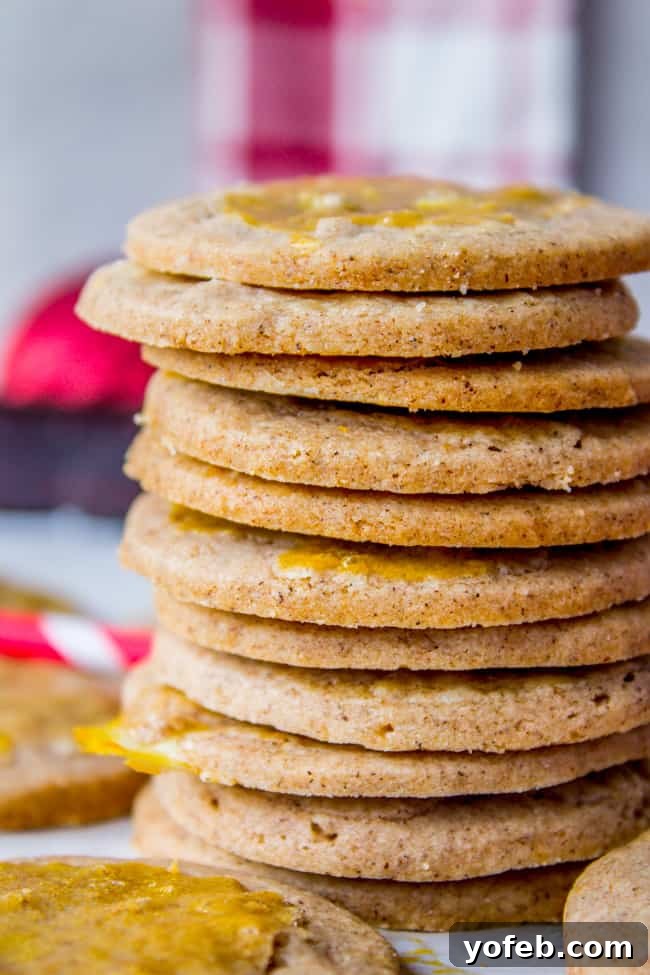 Swedish Cardamom Crisp Cookies 2 A stack of perfectly golden-brown, crispy Swedish cardamom cookies, highlighting their appealing texture.