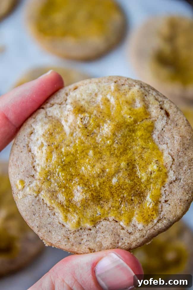 Swedish Cardamom Crisp Cookies 4 A crispy spice cookie on a baking sheet, brushed with an egg wash for a golden finish.