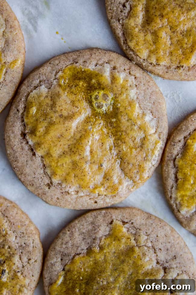 Swedish Cardamom Crisp Cookies 5 A close-up shot of multiple Swedish cardamom cookies, showcasing their delicate texture and golden hue.