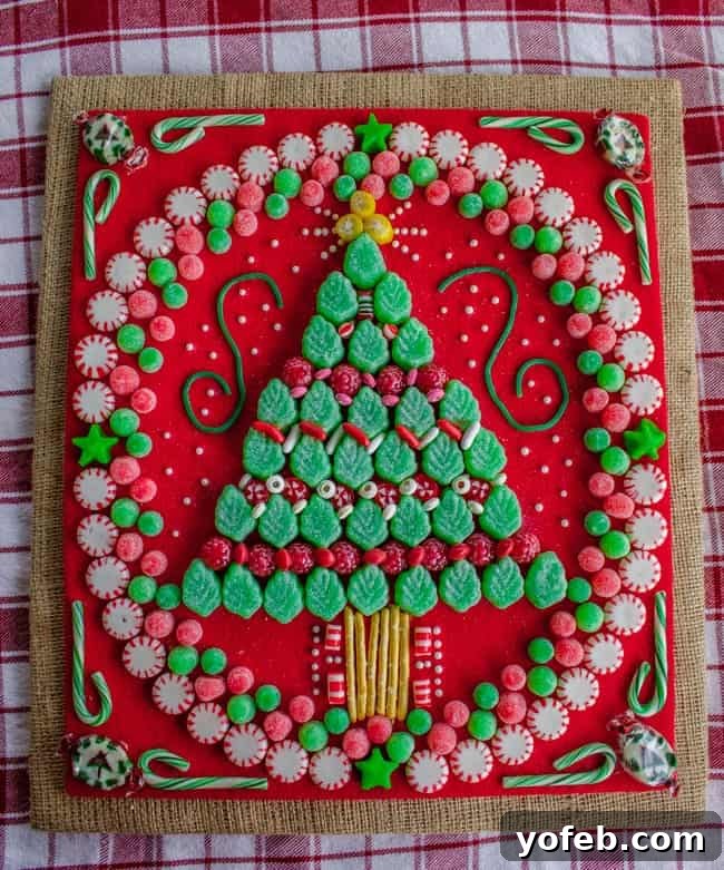 Creative DIY Candy Christmas Tree Decoration. Learn how to make your own Candy Christmas Tree craft to deck the halls this year! Get some felt and burlap and a TON of old fashioned candy and start glueing away. My mother-in-law still has the one she made 30 years ago! #christmas #tree #candy #oldfashioned #homemade #christmastree #holidays #candycrafts Creative DIY Candy Christmas Tree Decoration